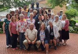 Group Of Visitors Posing Next To Joseph And Hyrum Smith Statue