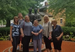 Group Of Visitors Posing Next To Joseph And Hyrum Smith Statue