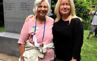 Two Ladies Posing Next To Eight Witnesses Monument