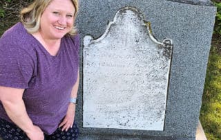 Woman Posing Next To Tombstone