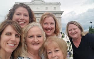 Group Of Visitors Posing In front Of Church