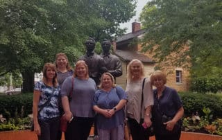 Group Of Female Visitors Next To Joseph And Hyrum Smith Statue